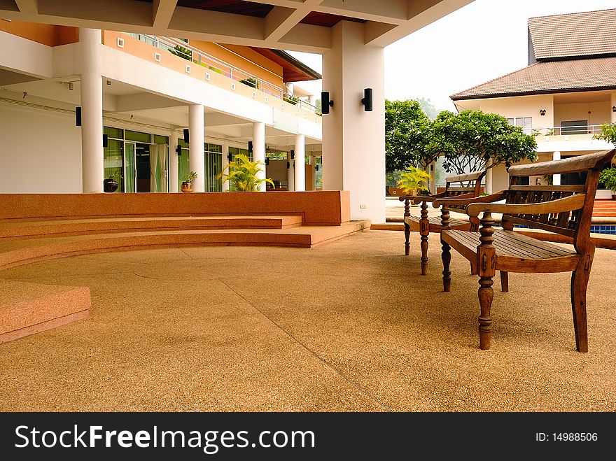 Two long wooden chairs in modern building, Chiangmai, Thailand. Two long wooden chairs in modern building, Chiangmai, Thailand