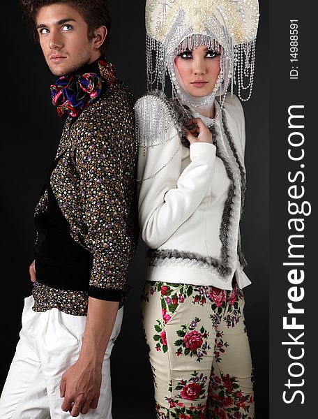 Pair models in exclusive design clothes on manners old-slavic. Photo.