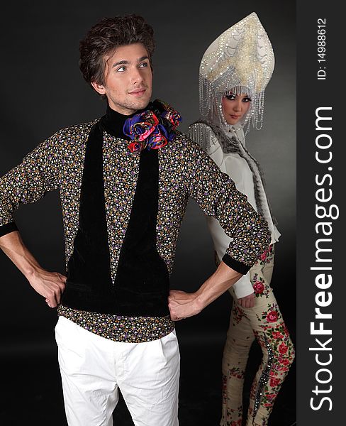 Pair models in exclusive design clothes on manners old-slavic. Photo.