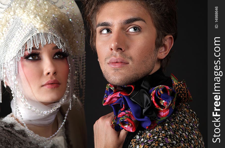 Pair models in exclusive design clothes on manners old-slavic. Photo.