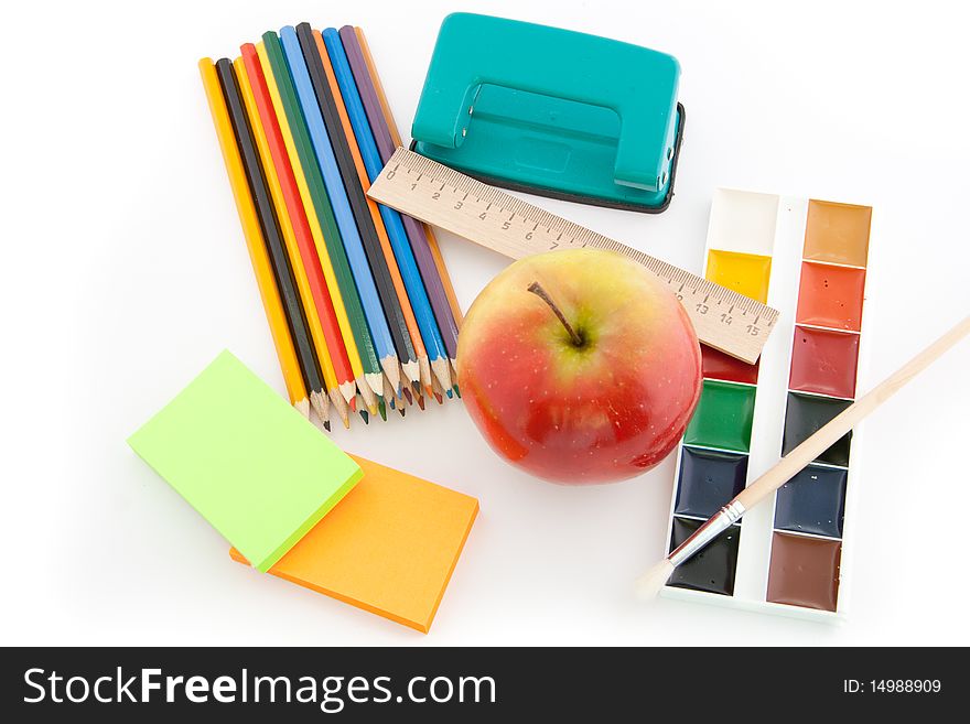 Stationary with a red apple isolated on a white background. Stationary with a red apple isolated on a white background