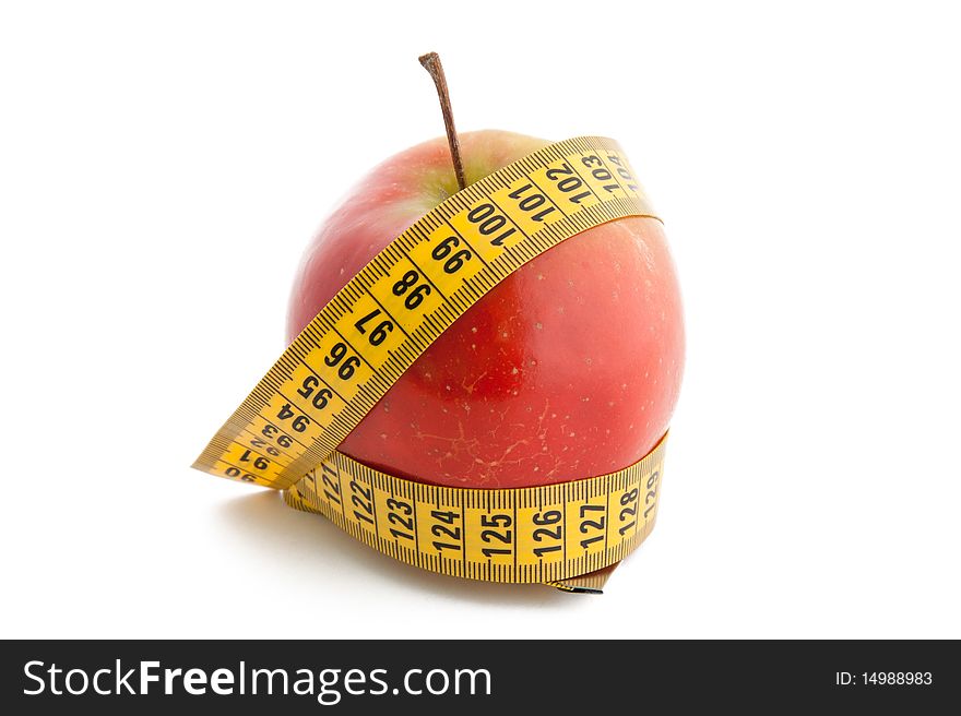 Yellow  tape measure around a red apple representing dieting