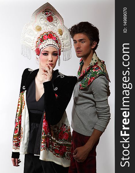 Pair models in exclusive design clothes on manners old-slavic. Photo.