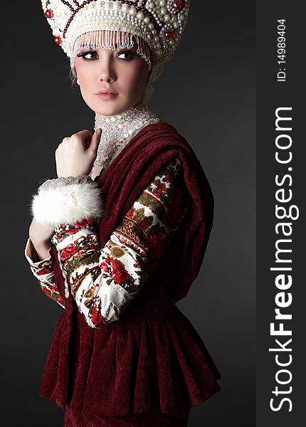 Attractive model in exclusive design clothes on manners old-slavic. Photo.