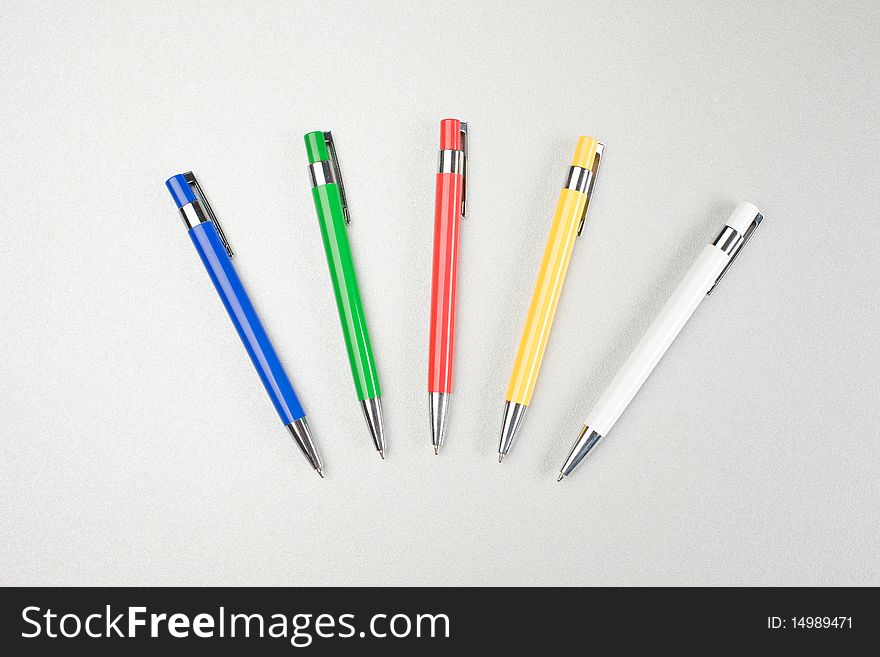 Set of colored pens on grey table. Set of colored pens on grey table