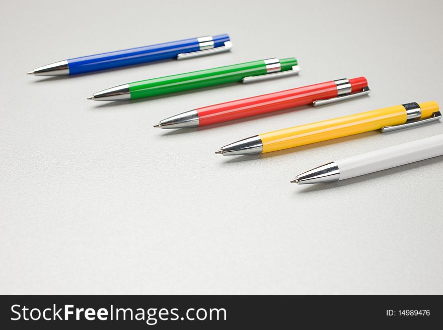 Set of colored pens on grey table. Set of colored pens on grey table