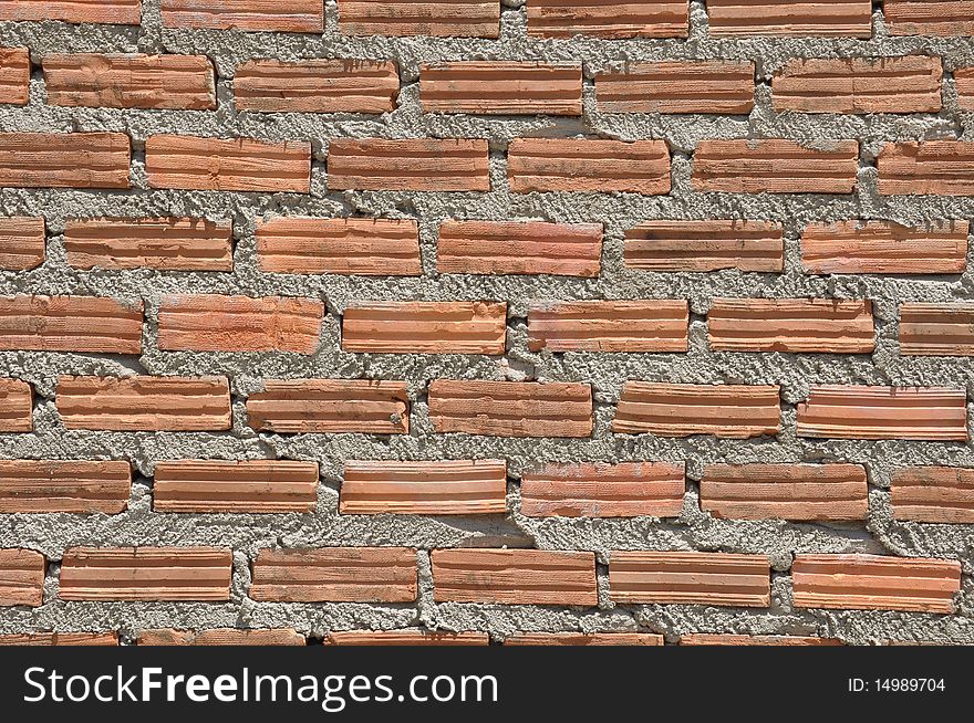 Brown color brick wall in the similar pattern