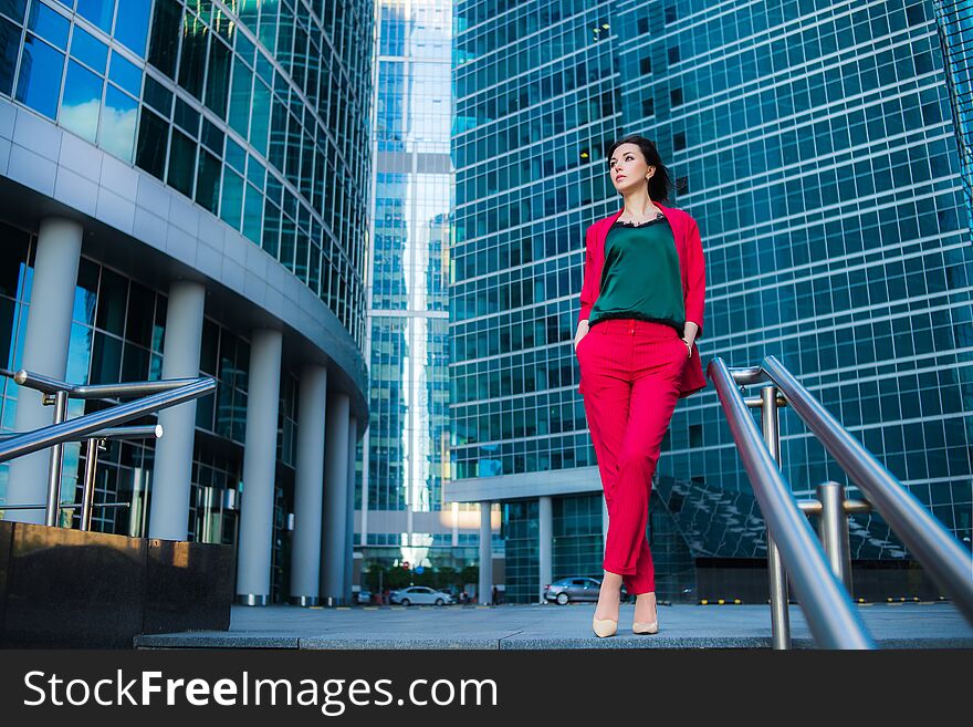 Street fashion business style, attractive model on skyscrapers background. Success concept