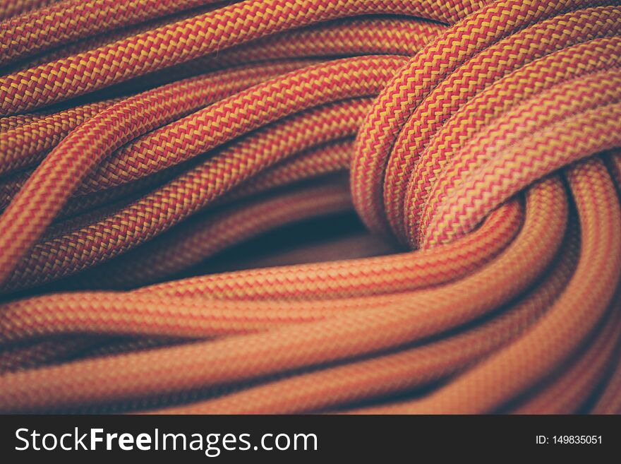 Orange rope for climbing and climbing. background image of the rope for active sports. Orange rope for climbing and climbing. background image of the rope for active sports