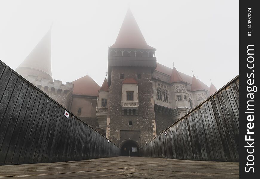 Interior and exterior of the Hunedoara castle in Romania in foggy conditions