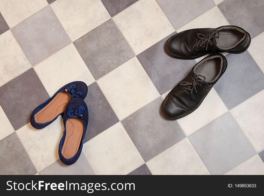 Light and comfortable blue women`s shoes and man`s shoes on  black and white checkered floor
