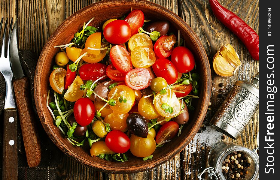 Tomato salad with oil and olives in bowl