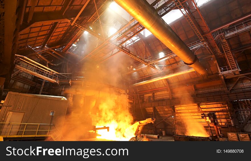 asting ingots in foundry shop, metallurgical production. Melting steel at the plant, heavy industry and dangerous work process. asting ingots in foundry shop, metallurgical production. Melting steel at the plant, heavy industry and dangerous work process.