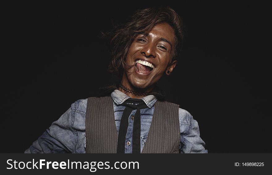 Cheerful african male isolated on black background. Close up of an excited african man looking at camera. Cheerful african male isolated on black background. Close up of an excited african man looking at camera