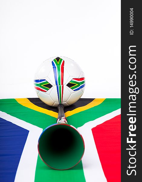 Image of a soccer ball on a South African flag with a Vuvuzela and team flags. Image of a soccer ball on a South African flag with a Vuvuzela and team flags