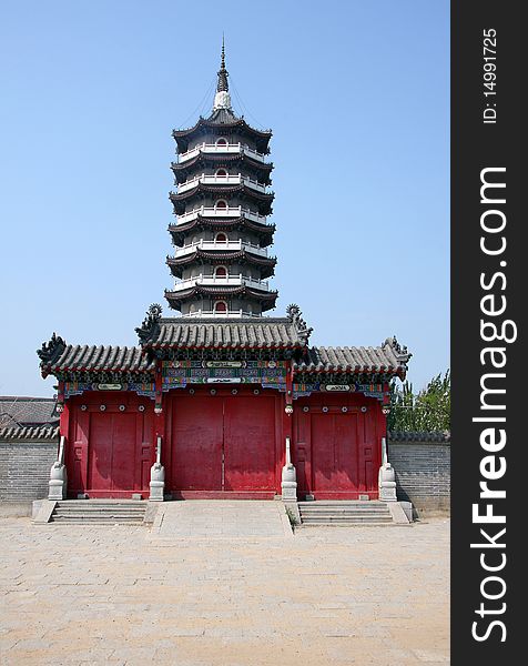 A traditional red door before a pagoda at temple in Yingkou, China. A traditional red door before a pagoda at temple in Yingkou, China.