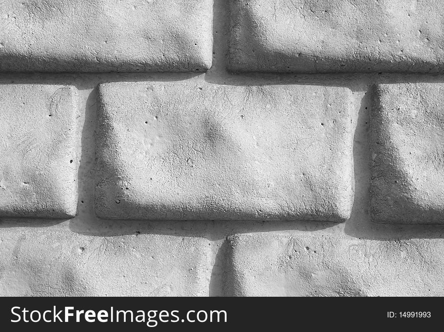 A light grey brick wall. A light grey brick wall