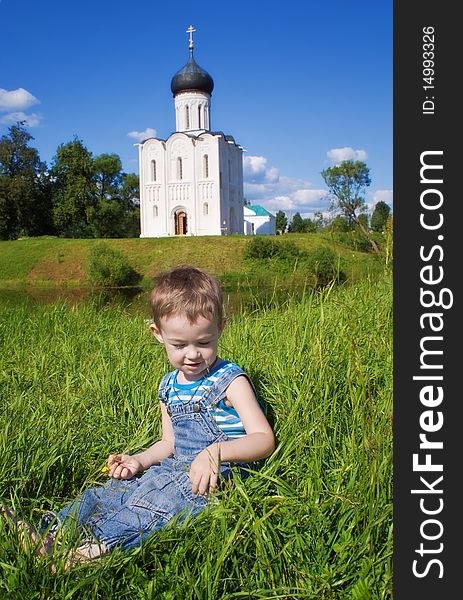 Little boy on a orthodox church background. Church of the Intercession on the Nerl, Vladimir region of Russia. Little boy on a orthodox church background. Church of the Intercession on the Nerl, Vladimir region of Russia