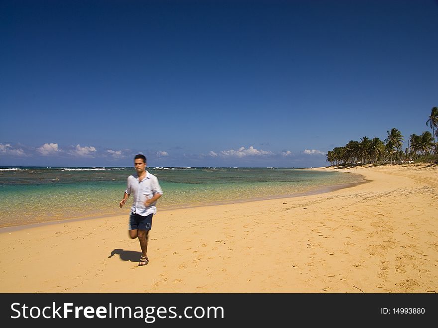 A man jogging in a beautiful desert beach. A man jogging in a beautiful desert beach