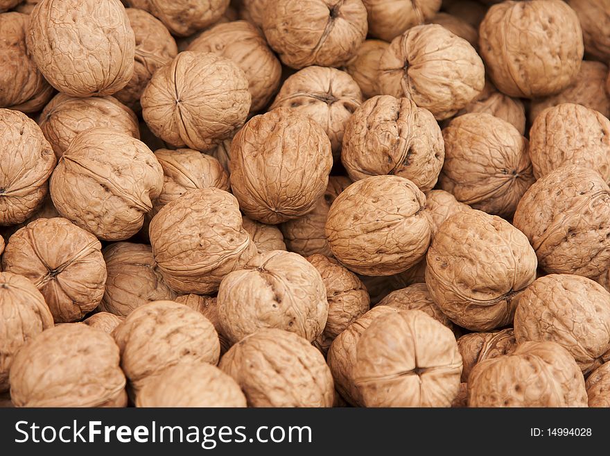 Close up of walnuts in their shells.