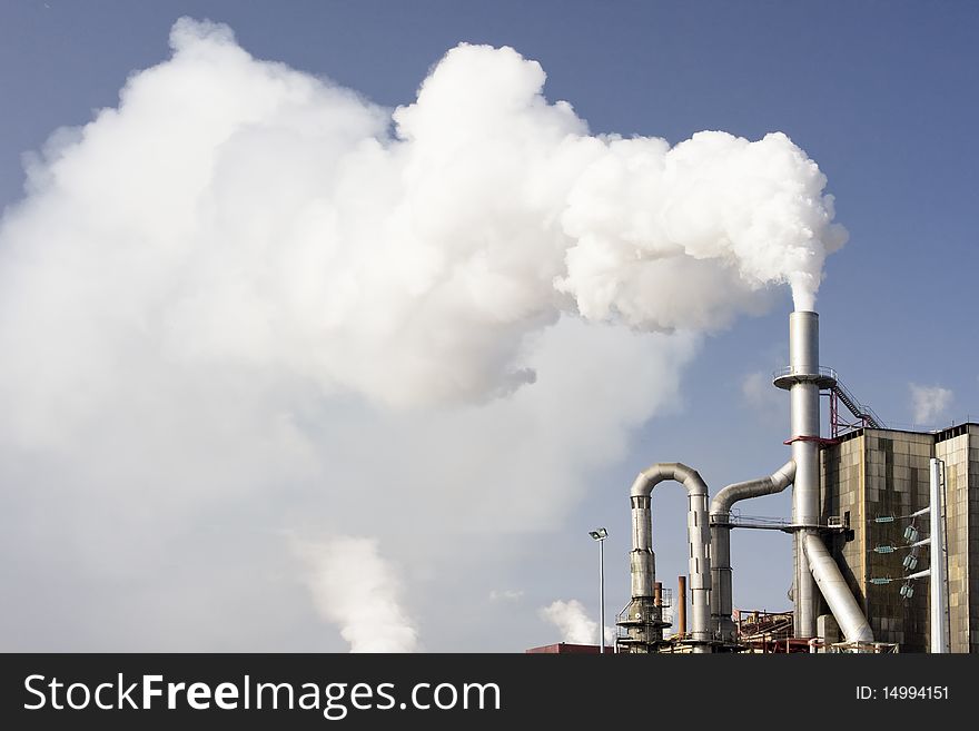 Scary image of white smoke coming out of industrial chimney (ecology problems)