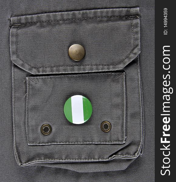 A pin identifying a Nigeria supporter or a travelling to Nigeria concept.