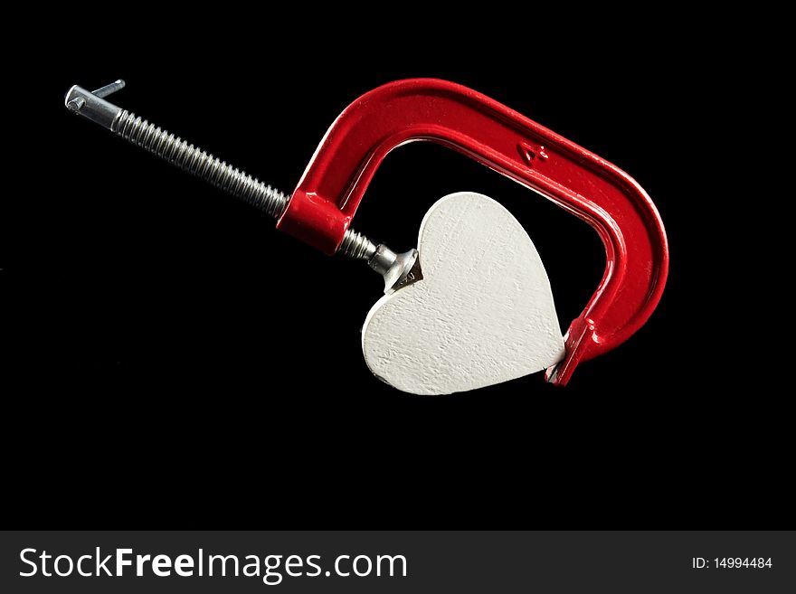 A red clamp with heart; heart under pressure