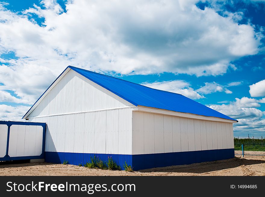 White building with a blue roof