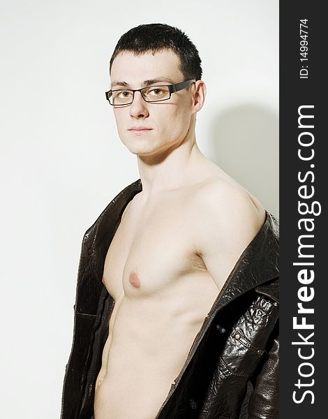 Portrait of young man in a leather jacket and glasses. Portrait of young man in a leather jacket and glasses