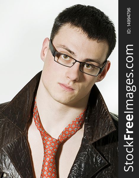 Portrait of young man in a leather jacket and glasses. Portrait of young man in a leather jacket and glasses