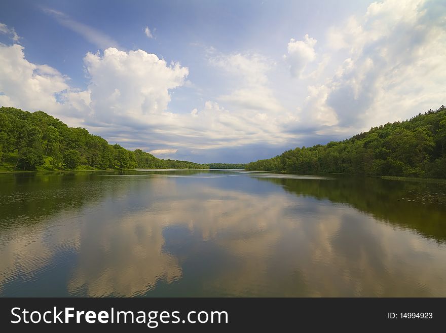 Summer lake, green coast, blue sky