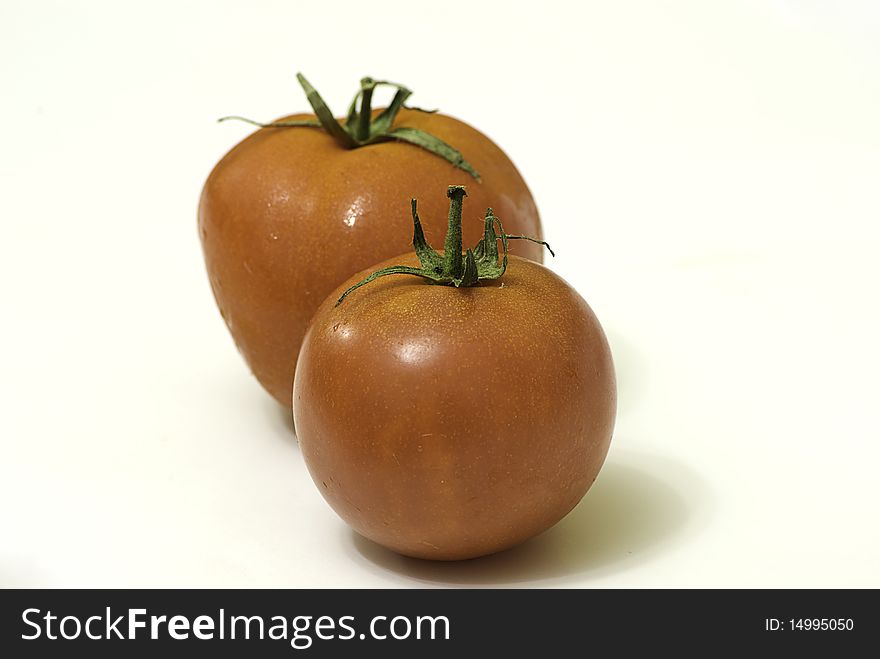 Ripe red tomatoes on white background