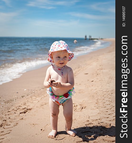Image of the happy baby on the beach