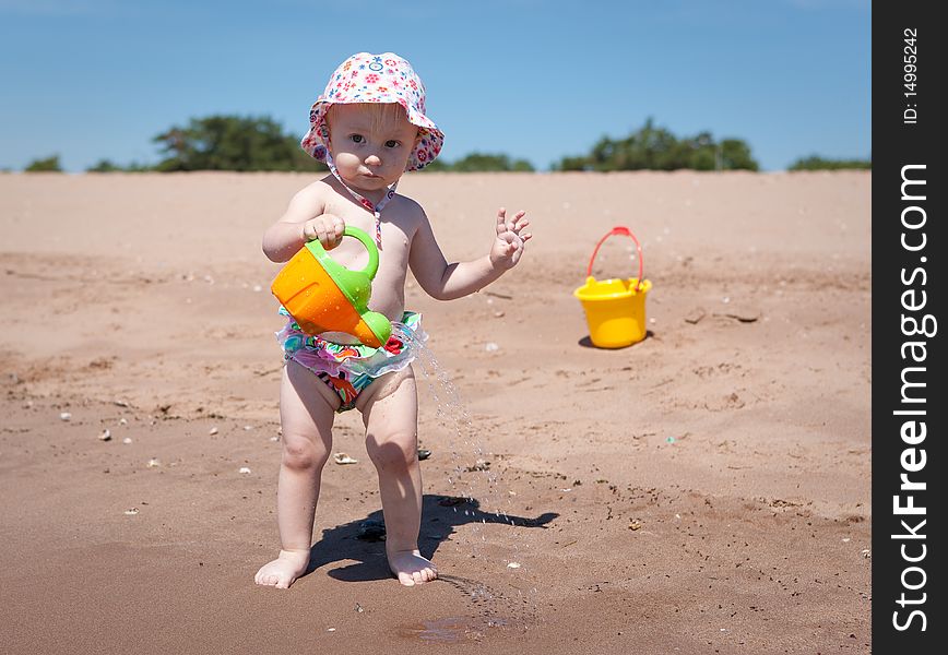 Image of the happy baby playing on the beach