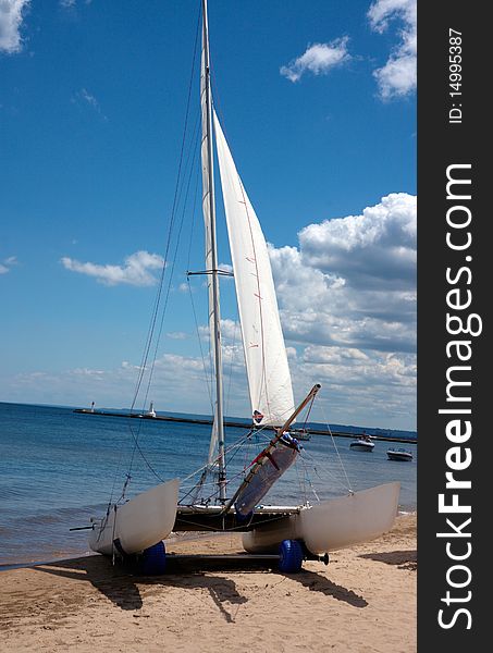 Boat in a lake ready to sail with blue sky and white clouds