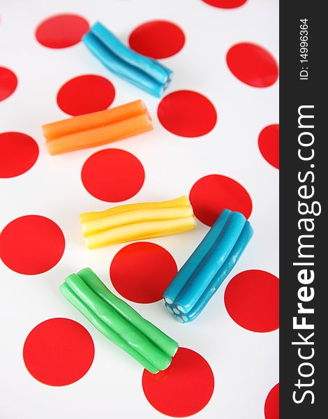 Colorful sweets on a red and white polkadot background