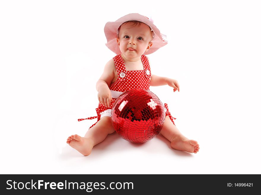 Little baby girl in red dress and hat with red ball