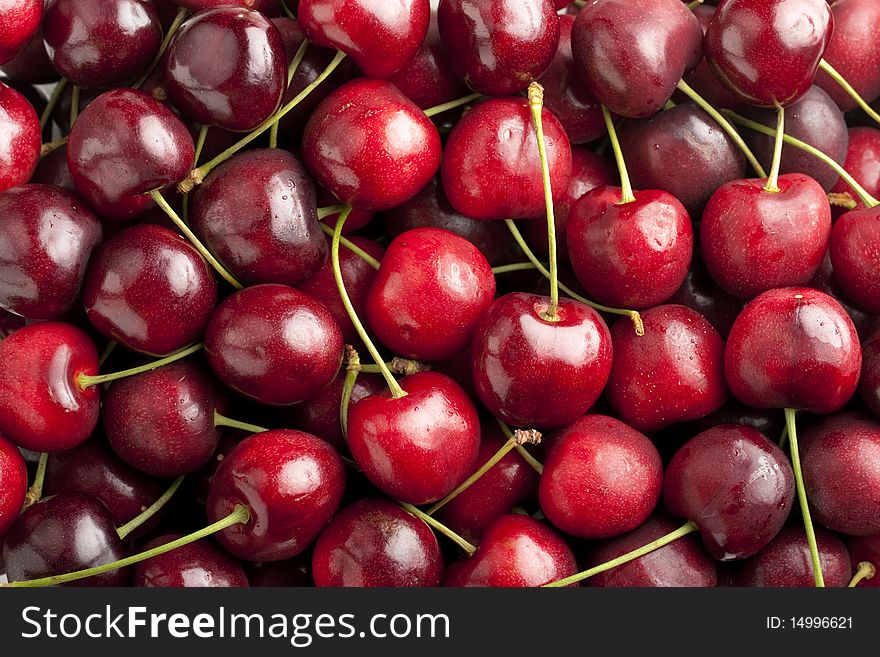 Red cherries in heap with focus across cherries on top layer. Red cherries in heap with focus across cherries on top layer.