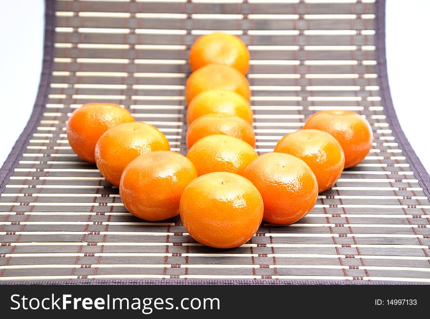 Mandarin baby orange on bamboo table cloth