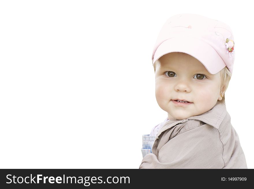 The joyful child in a pink cap looks back back. The joyful child in a pink cap looks back back