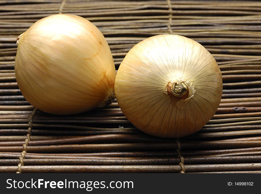 Pair of onions on bamboo mat