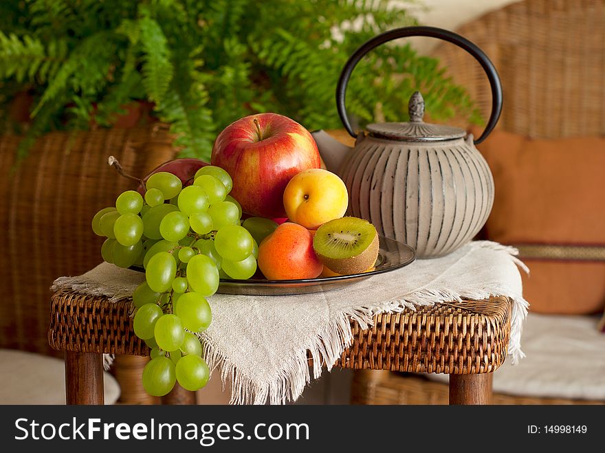 Beautiful still life image of fruits and teapot in