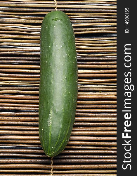 Fresh green cucumber vegetable on bamboo mat