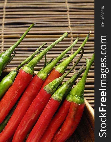 Red and green chili peppers on bamboo mat. Red and green chili peppers on bamboo mat