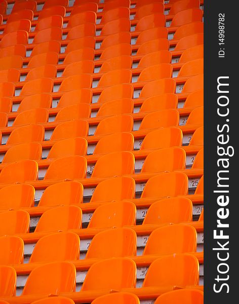 Orange empty stadium seats in a row
