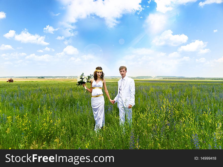 Just married couple on the green field