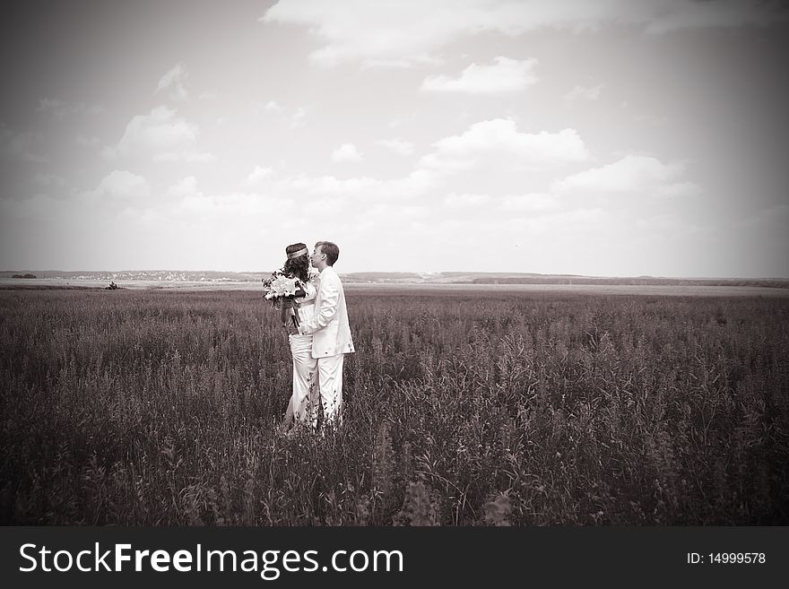 Just married couple on the field. black-and-white photo