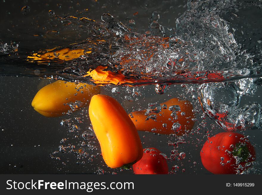 Peppers diving into water splashing