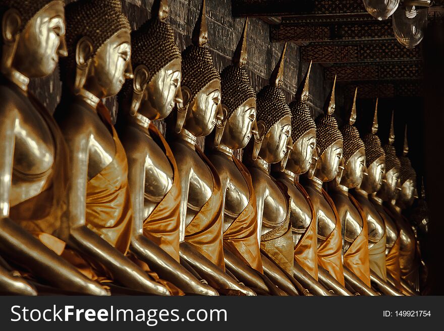 Golden Buddha Beside Old Walls In Thai Temples.