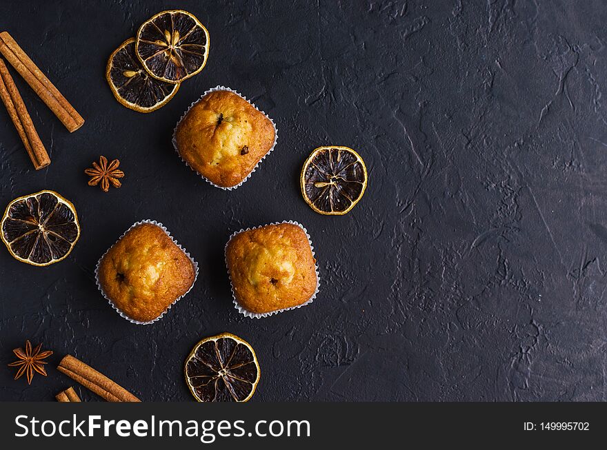 Sweet muffins with on dark textured background. Top view. Copy space.